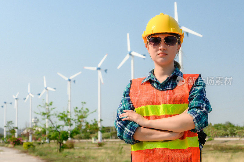 Engineering Asian women are working happily in nature, wind turbines, energy